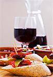 Pinchos with peppers and chorizo, served with red wine (Spain)