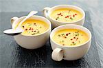 Creamy squash soup with curry and red peppercorns