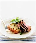 Slices of roast beef with barbecued potato