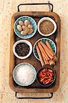 Assorted spices in bowls on a tray