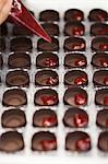 Filling Chocolate Molds with Raspberry Filling