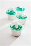 Cupcakes decorated with green icing and snowflakes