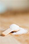 Granulated sugar on a wooden spoon