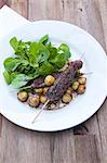 Venison skewers with watercress salad and chestnuts