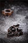 Antique Christmas cookie cutters in front of a Christmas cookie