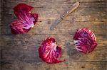 Radicchio with a knife on a wooden table