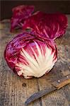 Radicchio with a knife on a wooden table