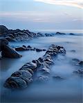 Long exposure of surf and rocks at sunrise, Tangalle, Sri Lanka, Indian Ocean, Asia