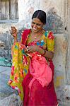 Young Indian Hindu girl age 20 sewing bridal veil at home in Tarpal in Pali District of Rajasthan, Western India