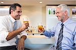 Business colleagues having beer at bar counter