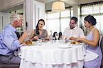 Business colleagues around dining table in restaurant