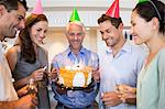 Group of people with champagne flutes and cake