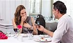 Man proposing a surprised woman in the restaurant