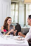 Man proposing a happy woman in the restaurant