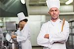 Head chef looking at camera holding wooden spoon