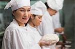 Happy chef holding dough smiling at camera