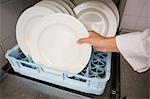 Chef putting plates in drying rack