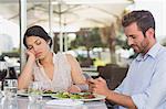 Bored woman being ignored by her date