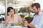 Bored woman being ignored by her date