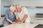 Happy senior couple listening to the phone