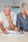 Worried senior couple organising their finances