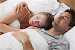 Young couple sleeping together in bed