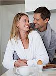 Loving young couple looking at each other in kitchen