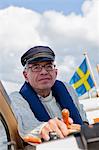 Senior man sailing, Grundsund, Bohuslan, Sweden