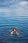Mid adult couple kissing in sea, Bohuslan, Sweden