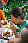 Woman eating at crayfish party, Sweden