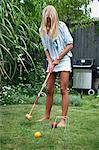 Teenage girl playing croquet, Sweden