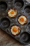 Eggs in baked hash brown nest with goat cheese and arugula filling