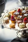 Petit fours on an elegant silver cake stand