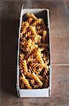 Wholemeal fusilli in a cardboard box