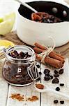 Homemade mince meat with cinnamon, ground spices and dried fruit in a pan and in a jar