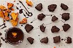 Pieces of honeycomb being dipped in dark melted chocolate