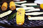 Corn cobs and courgettes on a barbecue