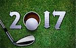 Happy New Golf year 2017,  Golf ball and putter on green grass.