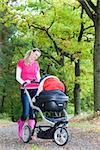 woman with a pram on walk in alley