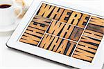 who, what, how, why, where, when, questions  - brainstorming or decision making concept - a collage of words in vintage letterpress wood type on a digital tablet with a cup of coffee