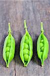 Green ripe pea vegetable isolated on old wooden background