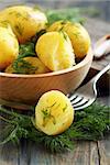 New potatoes with dill in a bowl closeup.