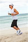 man is jogging on the beach summertime sport fitness run jogger runner