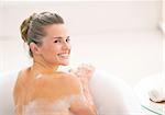 Portrait of young woman in bathtub