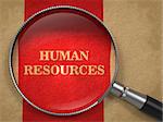 Human Resources. Magnifying Glass on Old Paper with Red Vertical Line.