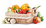 Fresh vegetables in wicker basket. Isolated on white background