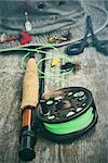 Fly fishing reel with old hat and equipment on bench