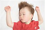 European caucasian Kid sleeping arms outstretched