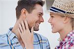 Young hip couple wearing check shirts facing each other on a sunny day in the city