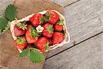 Fresh strawberry in basket on wooden table background with copy space